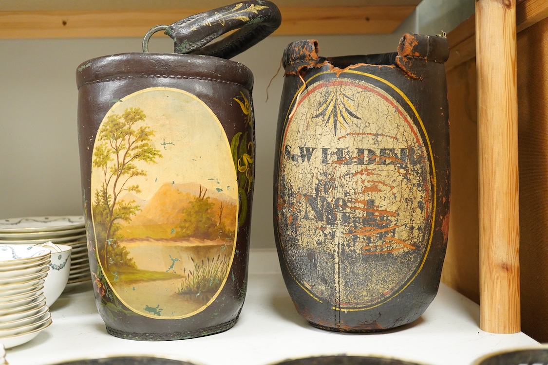 Two leather shot buckets, one with landscape cartouche, the other an advertising cartouche, 30cm high